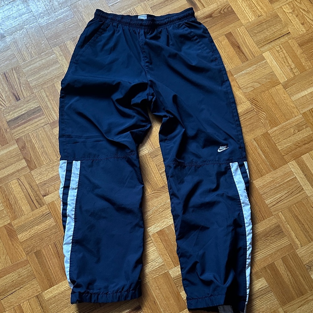 Nike Navy Track Pants with White Side Stripes and Small Swoosh
